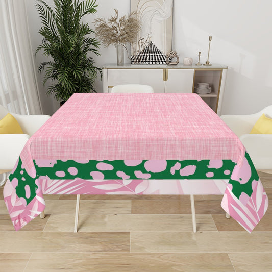 Pink and green patterned tablecloth on a dining table with a room setting in the background.