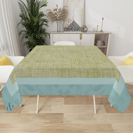 Green and blue patterned tablecloth on a dining table with a living room in the background